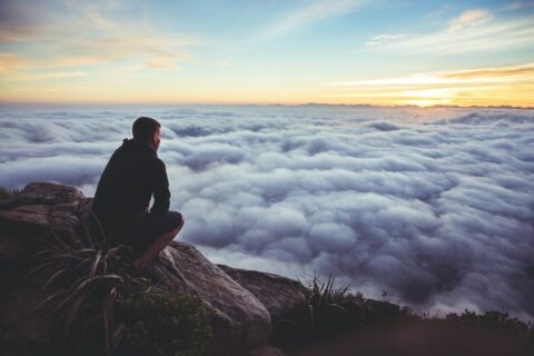 Man looking out over clouds